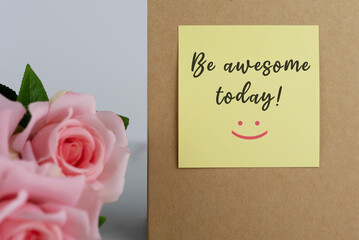 Pink rose and yellow adhesive note with inspirational quotes - Be awesome today