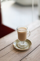 Glass cup of coffee latte on wooden table. High quality photo