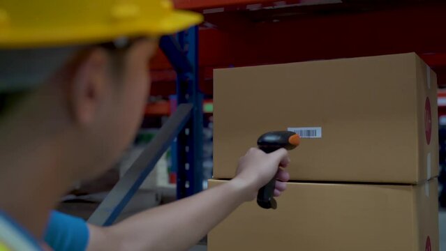Warehouse workers at large warehouses are using laser guns to target barcode stickers on boxes. To check the stock of products and check the number of products in each item.