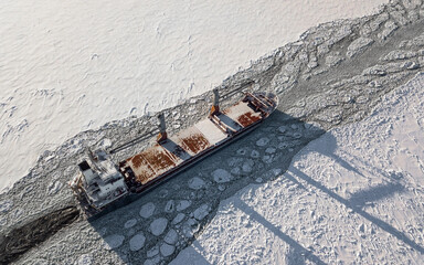 Aerial view of cargo ship in the sea at winter time