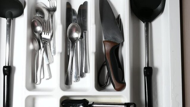 cutlery fork and knife in a drawer top view 