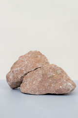 Empty natural stone podium on gray blue background, vertical photo