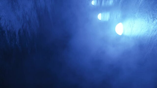 Animation flying through smoke in a narrow tunnel with blue lamps, light, technology, animation, drone, dark, futuristic, glowing, neon, 3d scene render 4k 3840x2160 three-dimensional looping video