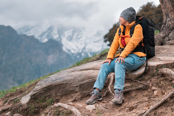 hiker in the mountains. Portrait of teenager girl hiker relaxing in mountains during Bhrigu Lake...