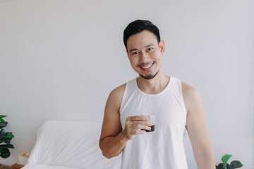 Asian man dink a shot of espresso coffee in his house for a fresh morning.