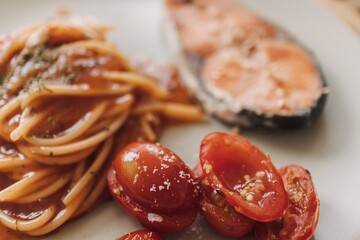 Homemade salmon spaghetti with tomato sauce served for lunch.