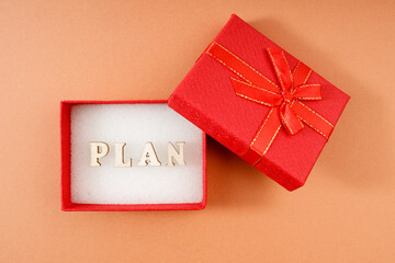 in a gift box, a word made up of wooden letters - a plan