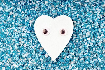 Obraz premium heart symbol with toy eyes on a background of blue stones