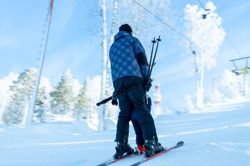 a parent rides a ski lift with a child uphill. child education