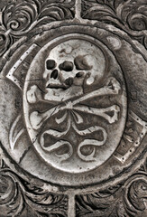 Skull and crossed bones motif on grave slab inside the Camposanto cemetery of the Campo dei Miracoli, Pisa, Tuscany, Italy