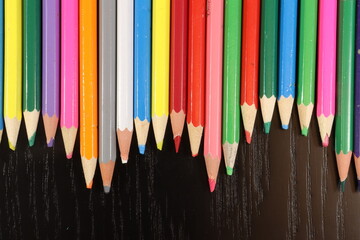 Colored pencil over a black wood table