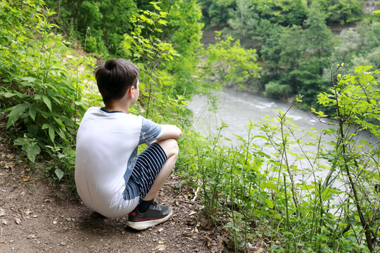 Child sitting on bank of Belaya River