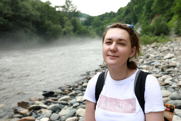 Woman sitting on bank of Belaya River