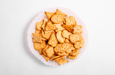 Dry salty cracker cookies on gray stone background.