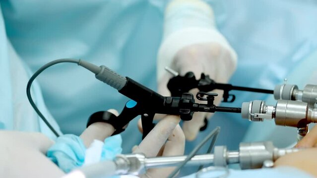 Hands of surgeons with the help of endoscopic equipment and instruments operate. performing laparoscopic surgery using endoscopic and laparoscopic instruments. laparoscopic instrument.