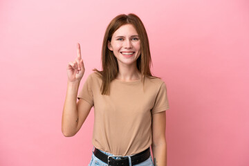 Young English woman isolated on pink background pointing up a great idea