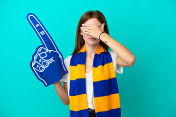 Young sports fan woman isolated on blue background covering eyes by hands. Do not want to see something