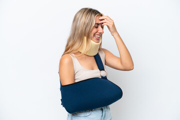 Woman with broken arm and wearing a sling isolated on white background laughing