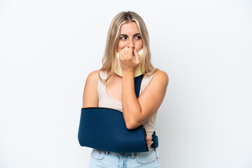 Woman with broken arm and wearing a sling isolated on white background having doubts