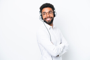 Telemarketer Brazilian man working with a headset isolated on white background with arms crossed and happy