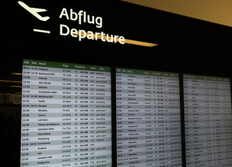 Flight departures board with international destinations at Vienna Airport