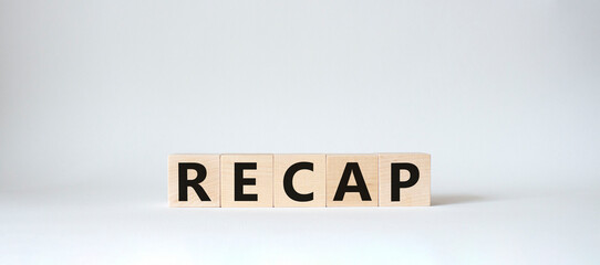 Recap symbol. Wooden cubes with word Recap. Beautiful white background. Recap concept. Copy space.