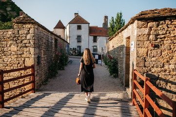 Woman walking down narrow street in European village
