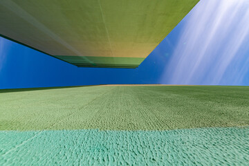 City buildings photographed with a wide-angle lens against the sky. Artistic noise is present.