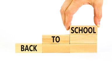 Back to school and support symbol. Concept words Back to school on wooden blocks. Businessman hand....