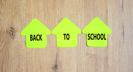 Back to school and support symbol. Concept words Back to school on green papers on wooden...
