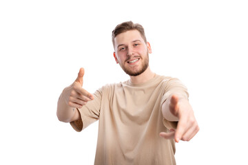 Handsome smiling man pointing index fingers on camera with happiness on his face. Positive guy making gun sign with hands over white background in studio.
