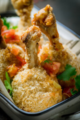 fried chicken legs on plate macro close up, vertical