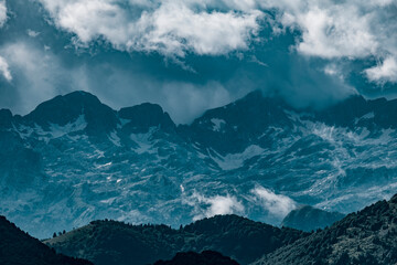 Stormy clouds over alpine peaks.