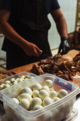 boiled eggs in a pilaf container. freshly boiled chicken eggs for Uzbek dish. ingredients for...