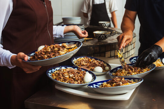 laying pilaf on Uzbek plates. packing pilaf in the pilaf center. lunch time in a cafe in tashkent. fatty rice with butter national dish of uzbekistan