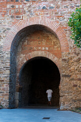 Door in the high wall under the clock tower in Buitrago de Lozoya, Madrid.