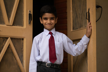 portrait of a student in school uniforrm at the door