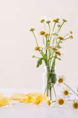 Chamomile flowers with bottle. Homeopathy background.