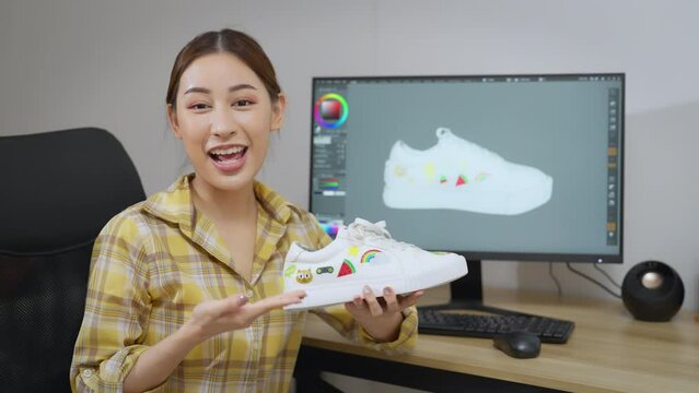 Young beautiful designer woman talking to camera at her office. She explaining about her product design to camera. Designer, Design, Creativity, Arts, Development, Ideas, Education concept.