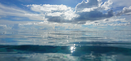 Sea surface with island at the horizon and blue sky with cloud, tropical seascape , Pacific ocean,...