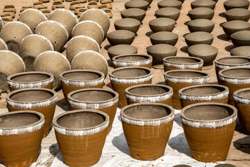 Terracotta pots put to dry before being baked. - obrazy, fototapety, plakaty
