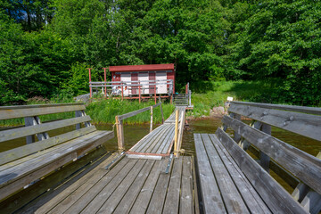 Fototapeta premium Small bathing platform and a sauna by a lake.