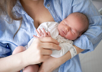 Newborn baby in mother's hands. Sleep the first days of life. happy kid. Cute little newborn baby...