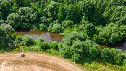 Aerial landscape of winding river in green field and trees. Beautiful nature background from drone.