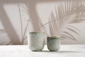 grey ceramic espresso and coffee mugs on a grey background