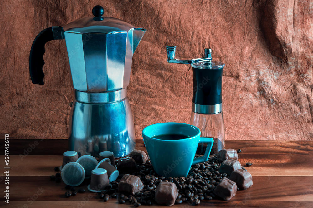 Wall mural coffee maker with coffee beans and chocolates background 