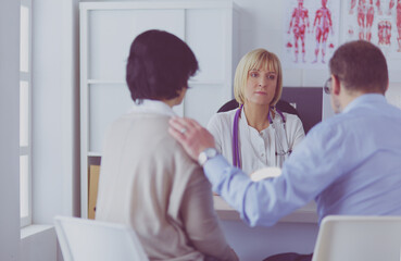 doctor talking to her male patient at office