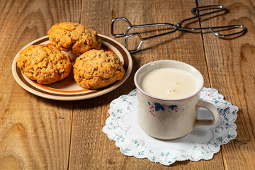 oatmeal cookies and glass of milk on woden table.