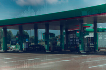 Gas station with fuel dispensers on technological background. Graph of rising prices for gasoline...