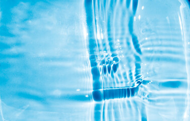 Naklejka na ściany i meble Beautiful oncoming waves, ripples on clear water, blue background